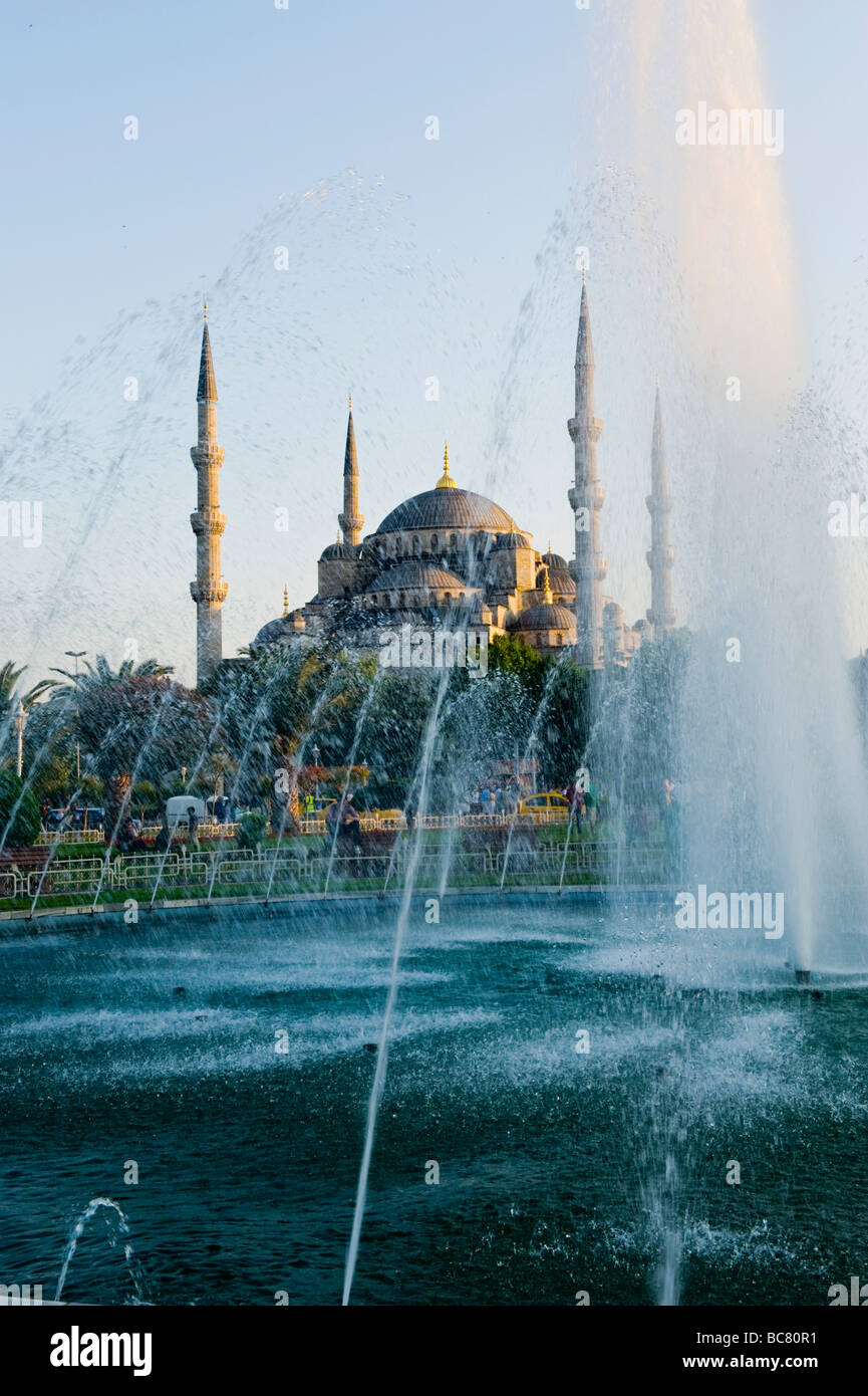 Turkey , Istanbul , the Blue Mosque or Sultan Ahmet Camii , from Sultanahmet Square or Meydani , at sunset with fountain Stock Photo