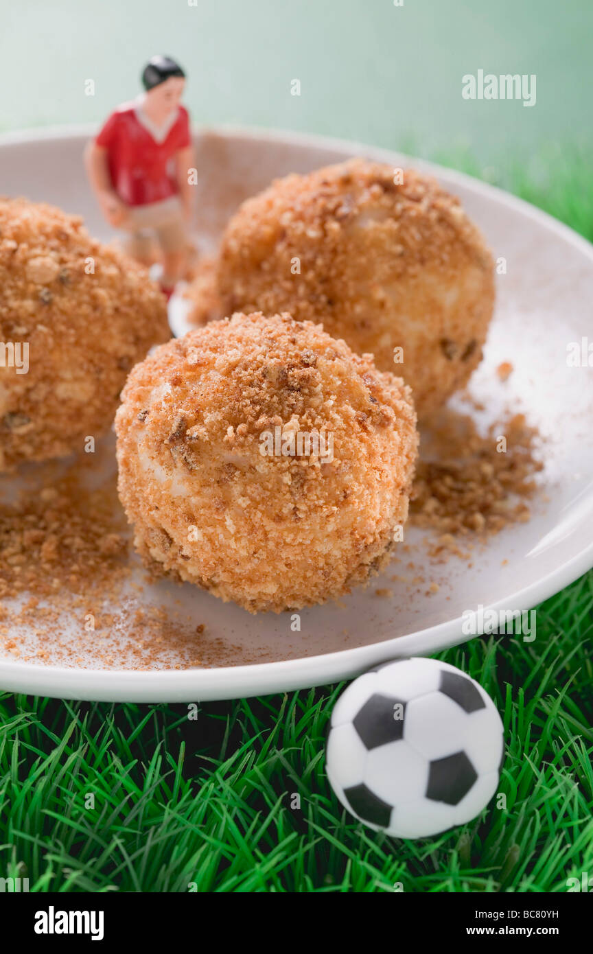 Apricot dumplings with football figure and football - Stock Photo