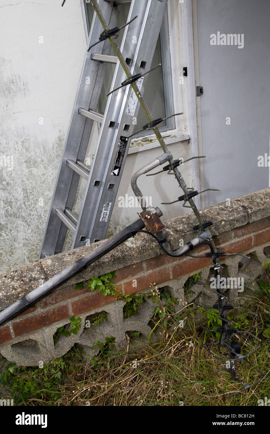 A very old tv aerial against an aluminium  ladder Stock Photo