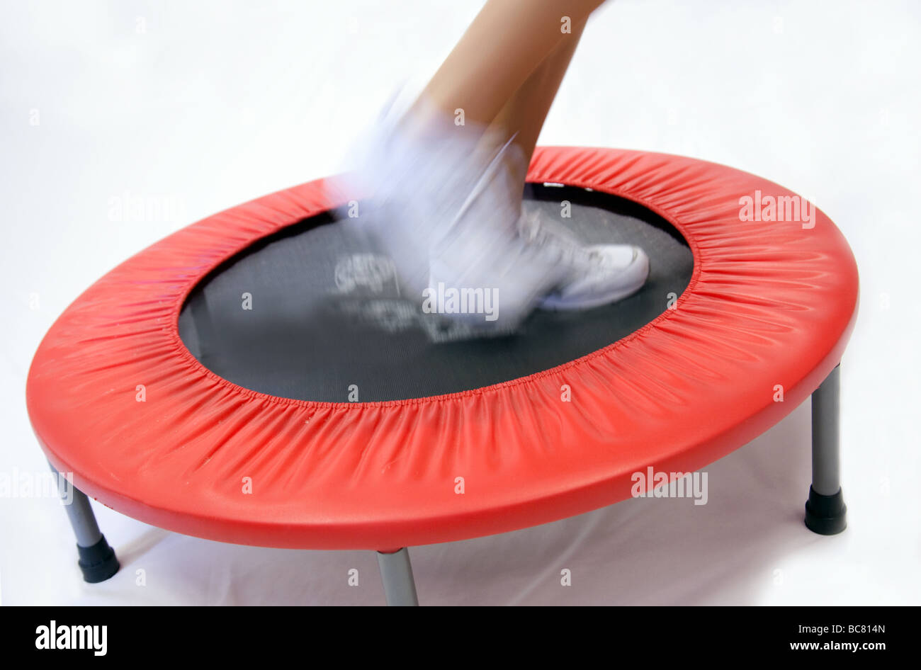 Close up of person exercising on a small trampoline in a gym Stock Photo