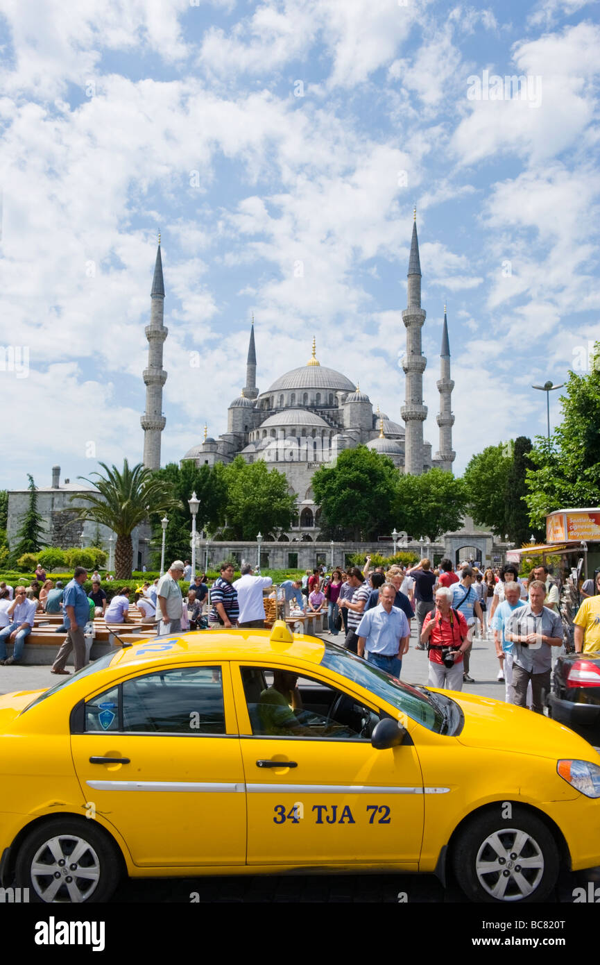 Turkey , Istanbul , The Blue Mosque or Sultan Ahmet Camii from Sultanahmet Square or Meydani , with yellow taxi or taksi Stock Photo