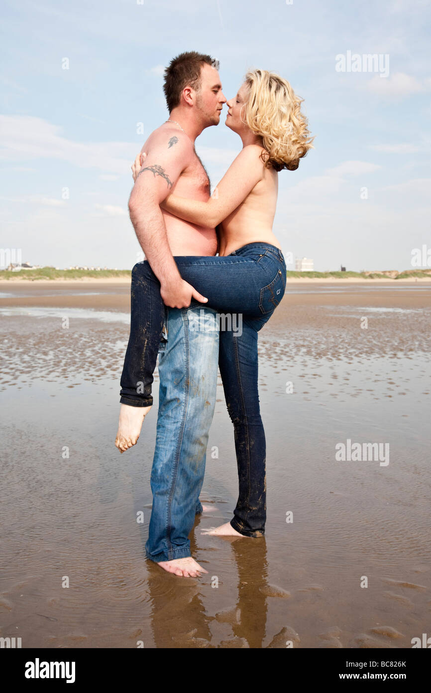 Young couples naked on the beach