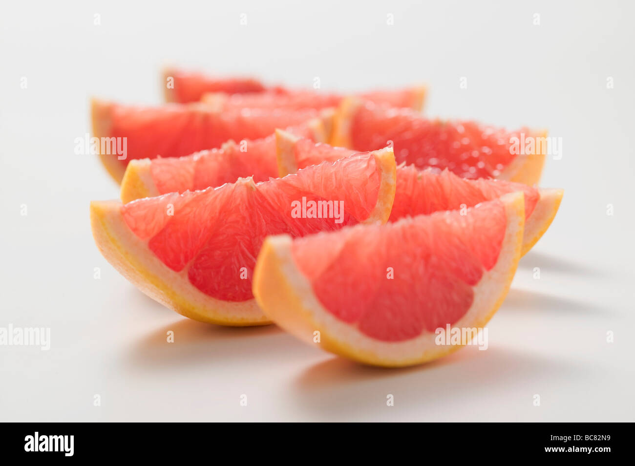 Wedges of pink grapefruit Stock Photo Alamy