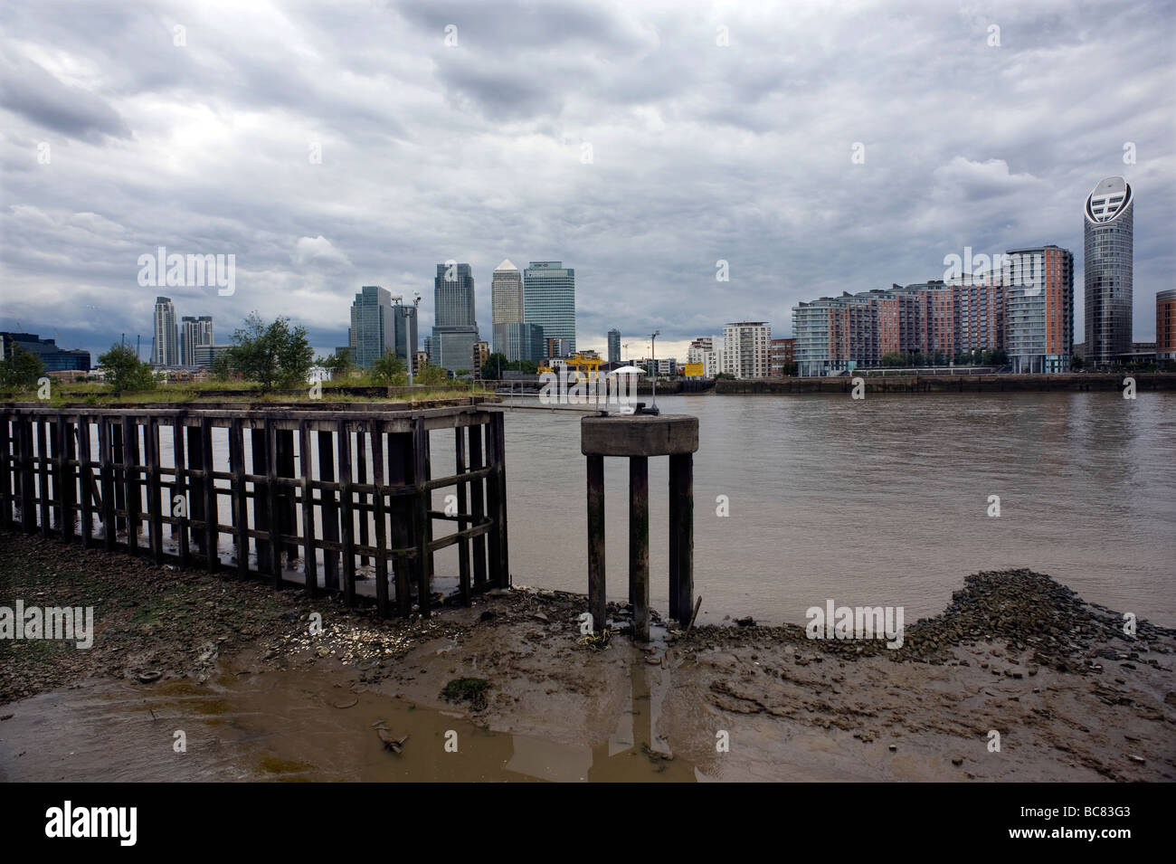 River Thames Canary Wharf Isle of Dogs Housing Offices modern London Britain apartments flats Riverside Footpath view Old wharf Stock Photo