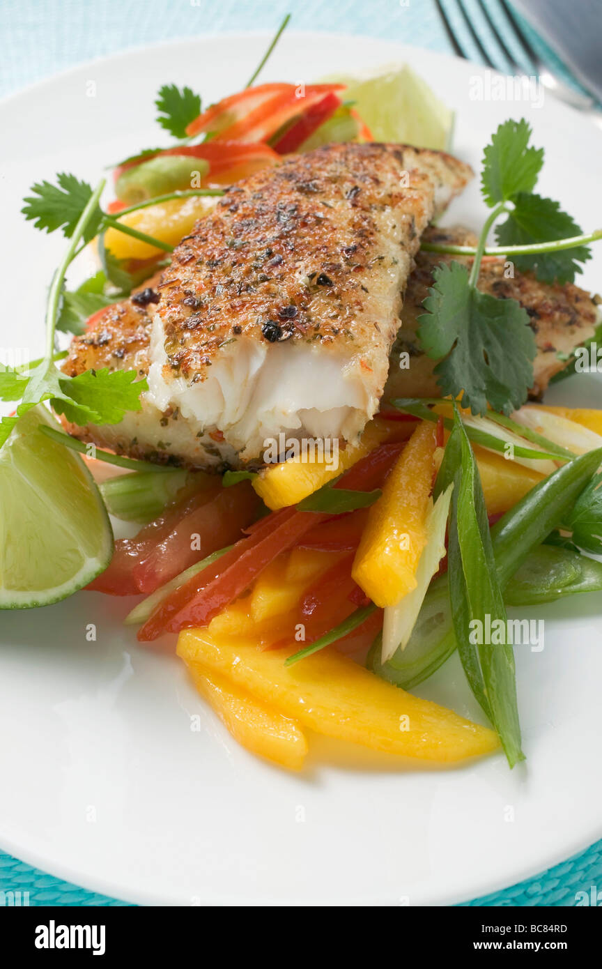 Spicy pangasius fillet with vegetables, lime, coriander - Stock Photo