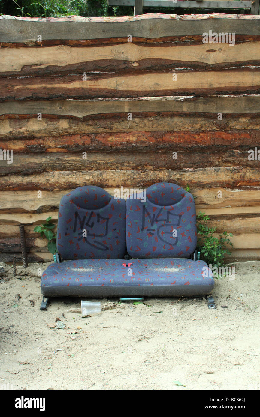 bus seats on ground by wood wall tacheles berlin art commune Stock Photo