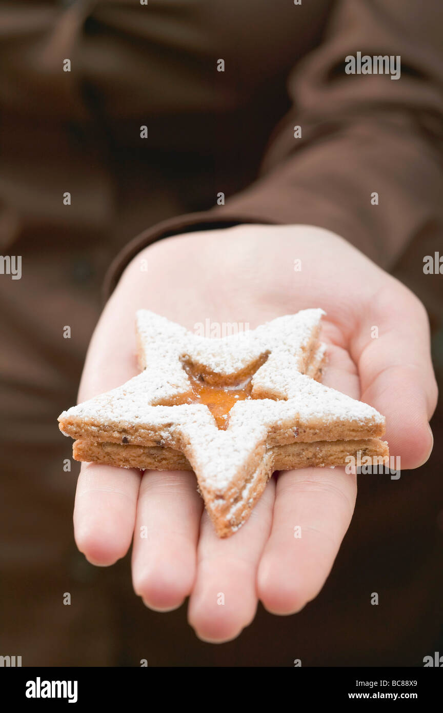 Hand holding jam biscuit Stock Photo Alamy