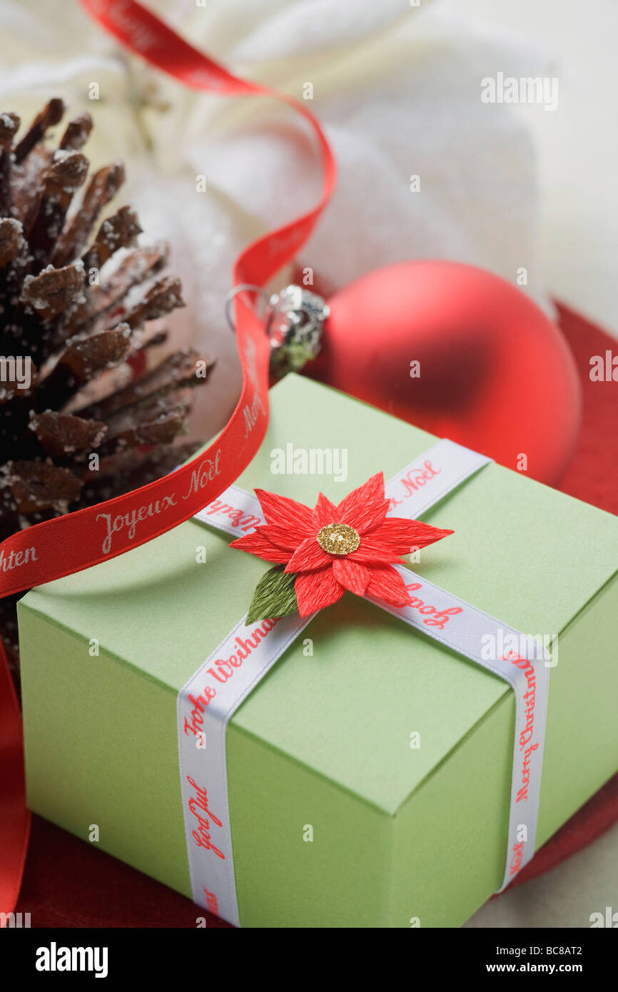 Christmas parcel, Christmas bauble and pine cone - Stock Photo