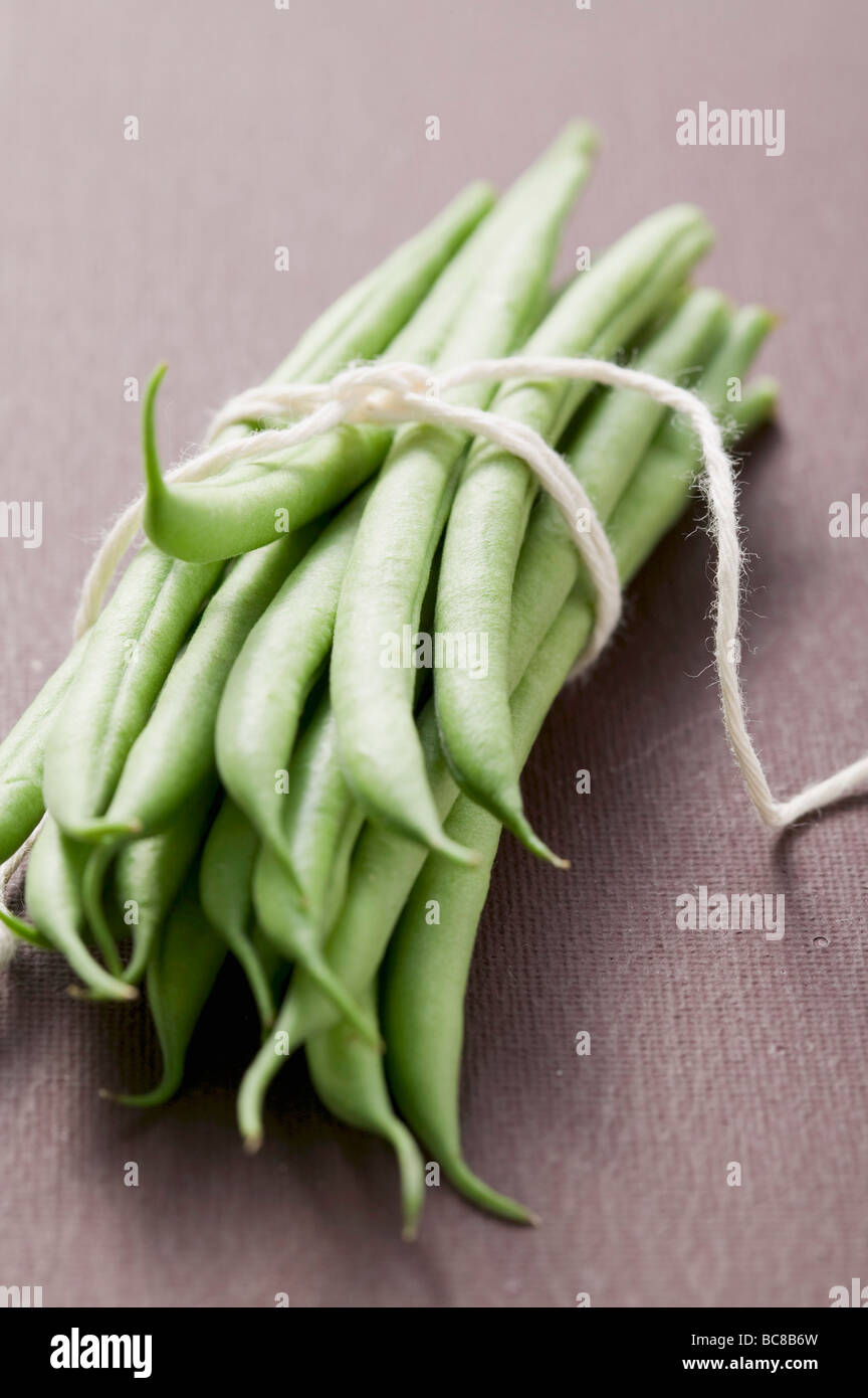 Several green beans, tied in a bundle Stock Photo - Alamy