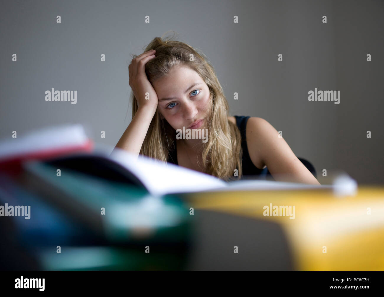 a teenager is doing her homework Stock Photo