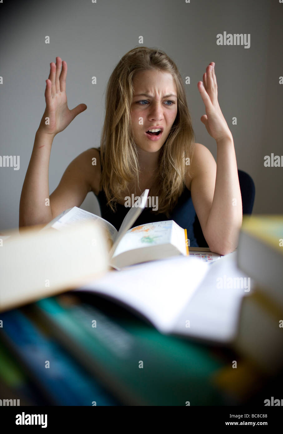 a teenager is doing her homework Stock Photo