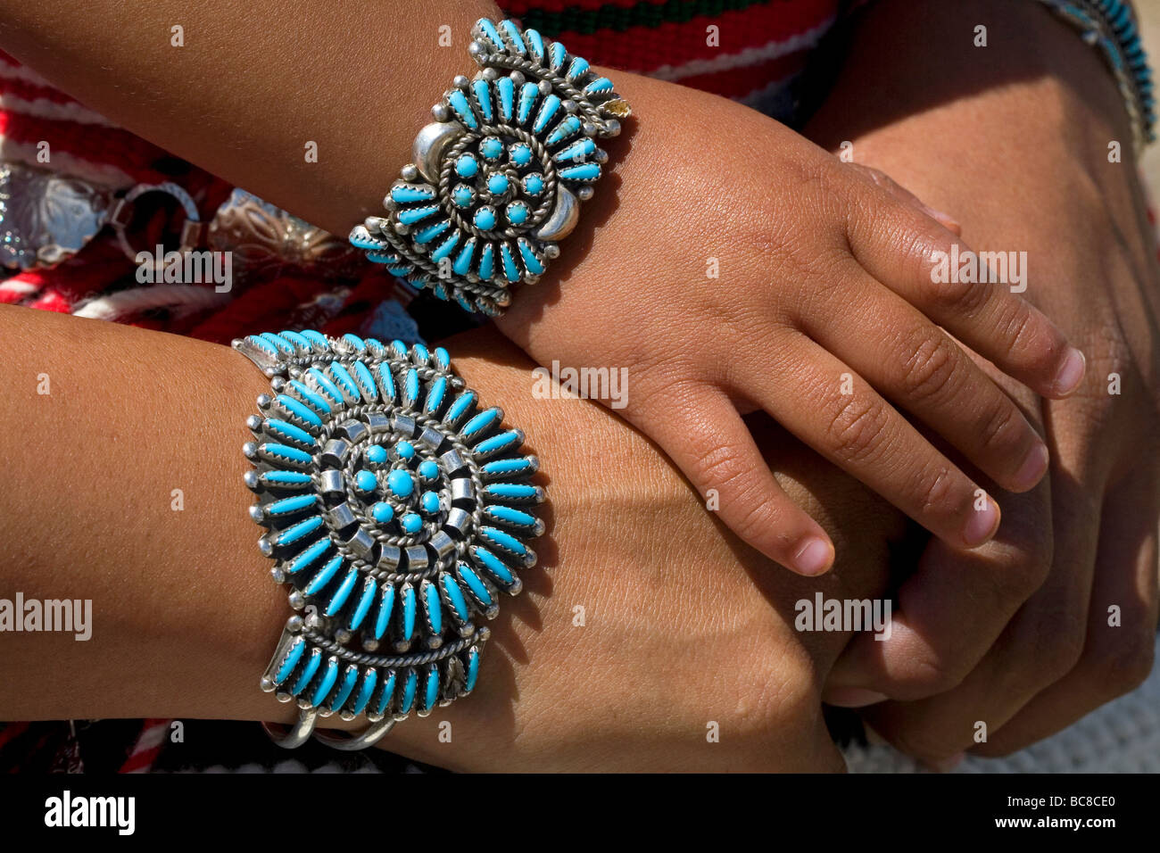 Turquoise bracelets crafted and worn by a Navajo Indian mother and daughter from Arizona USA Stock Photo