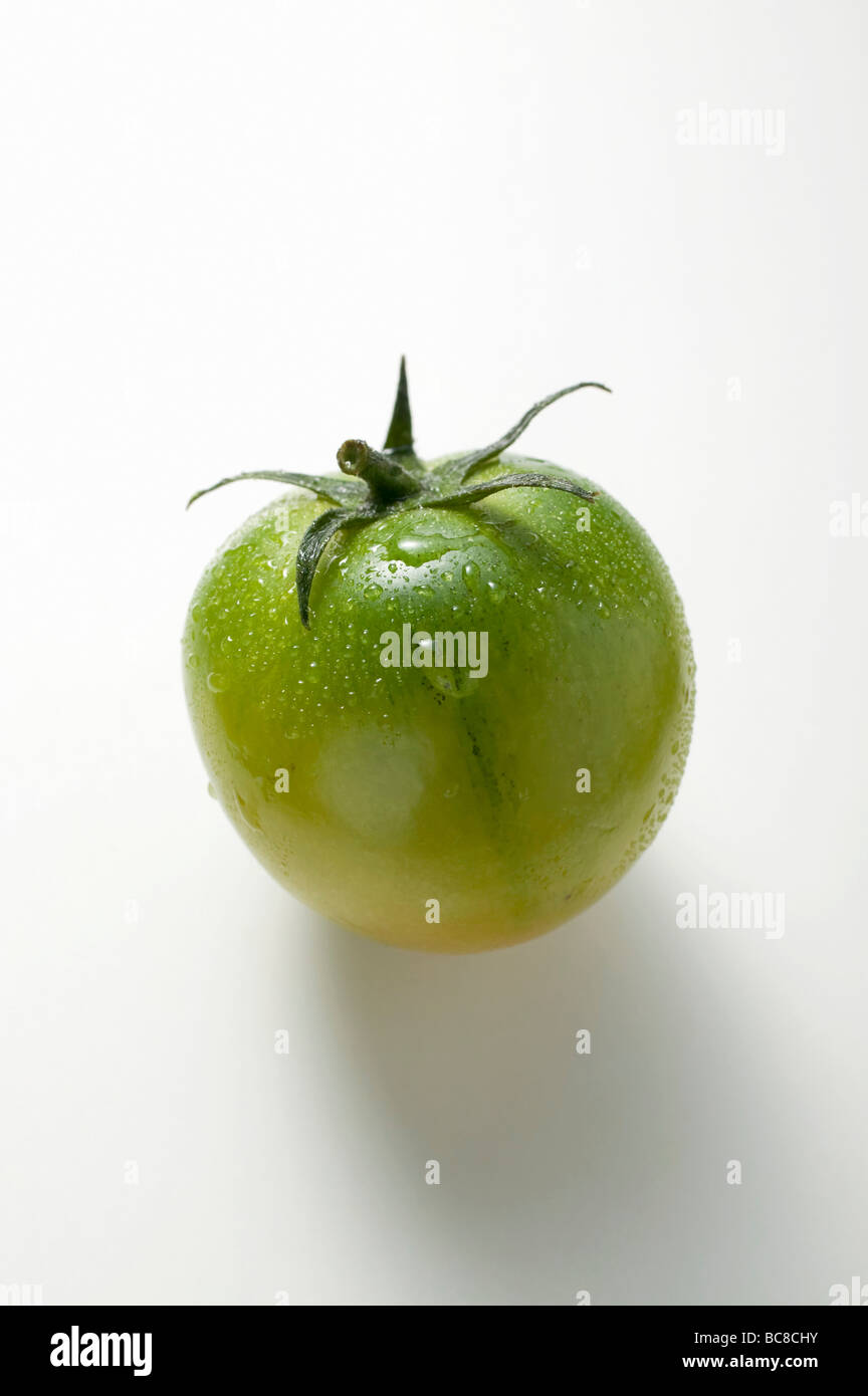 Green tomato with drops of water - Stock Photo