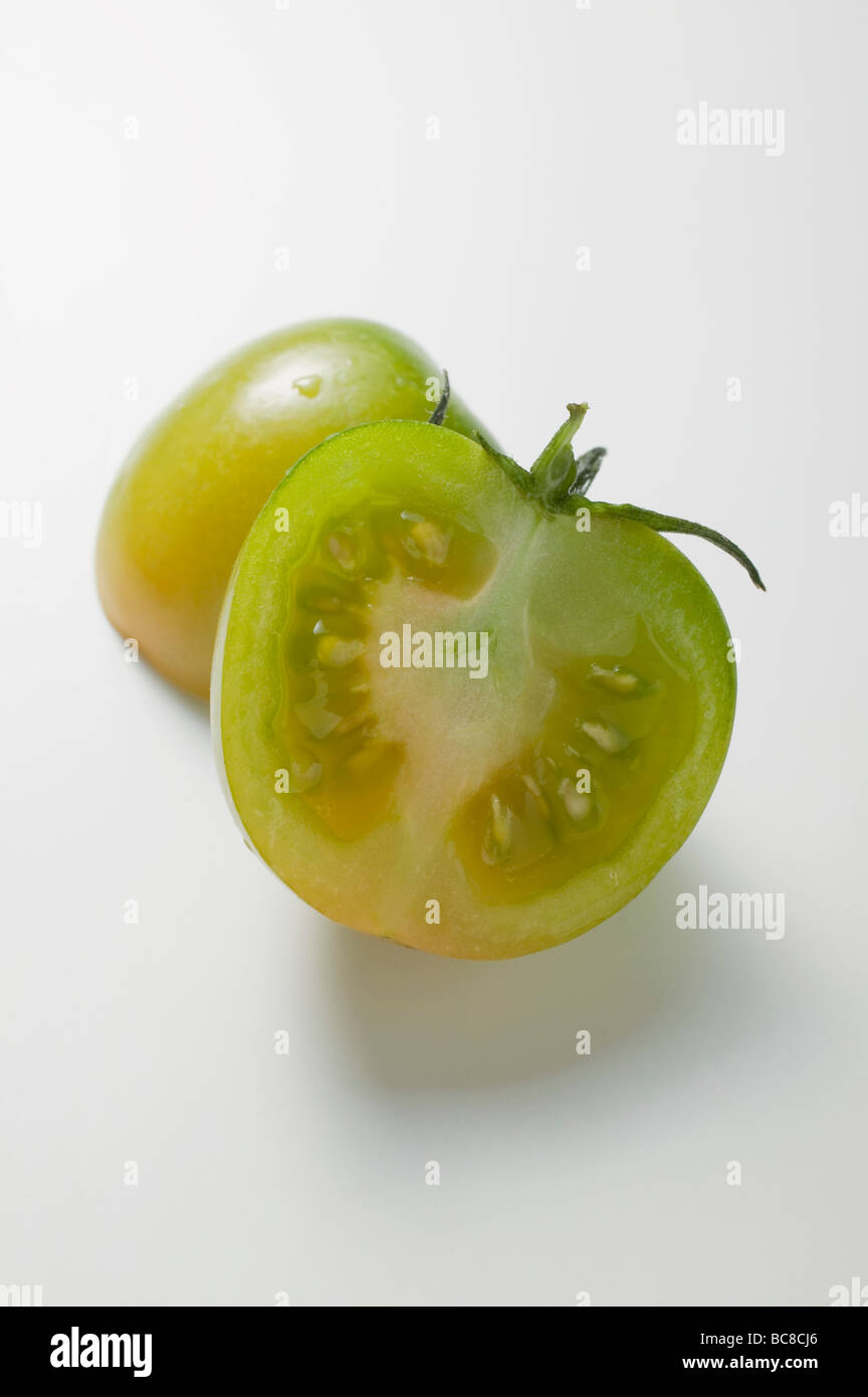 Green tomato, halved - Stock Photo