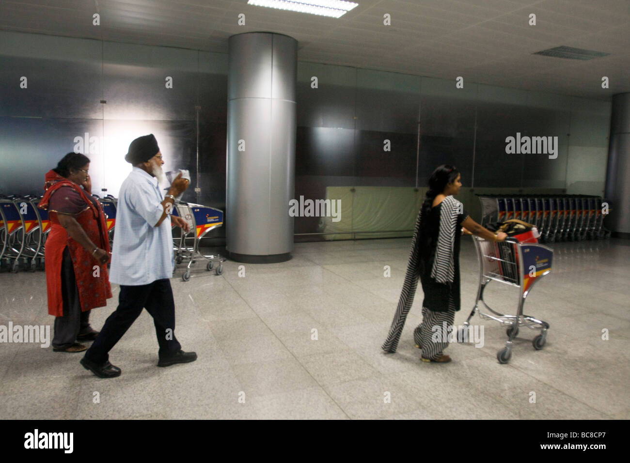 Indian airline passangers walk through the arrival hall of Rajiv gandhi international airport in Hyderabad in India Stock Photo