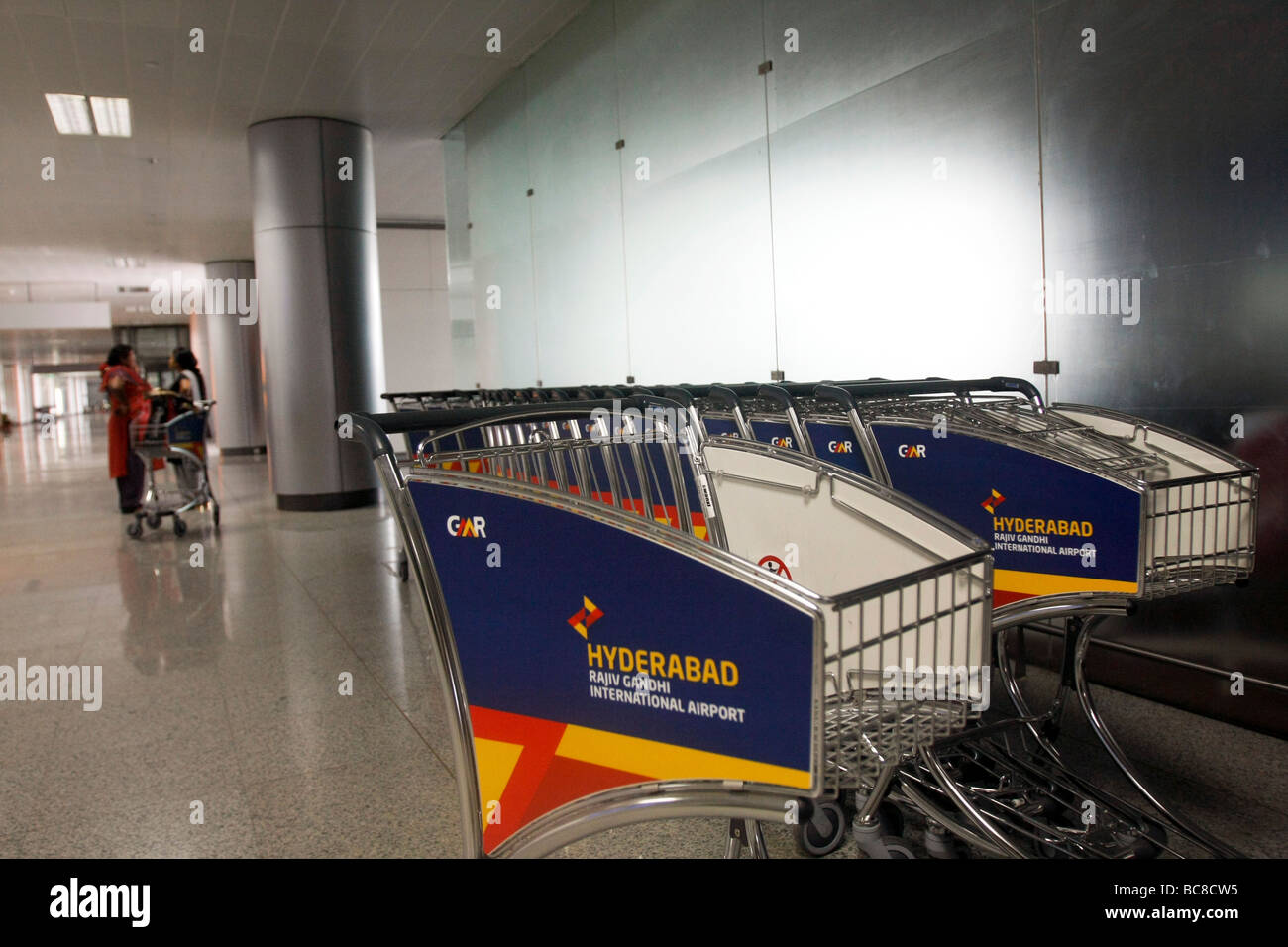Passangers and trolleys at the arrival hall at Rajiv Gandhi International airport in Hyderabad in India Stock Photo