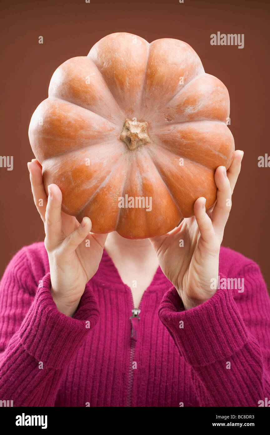Woman holding pumpkin - Stock Photo