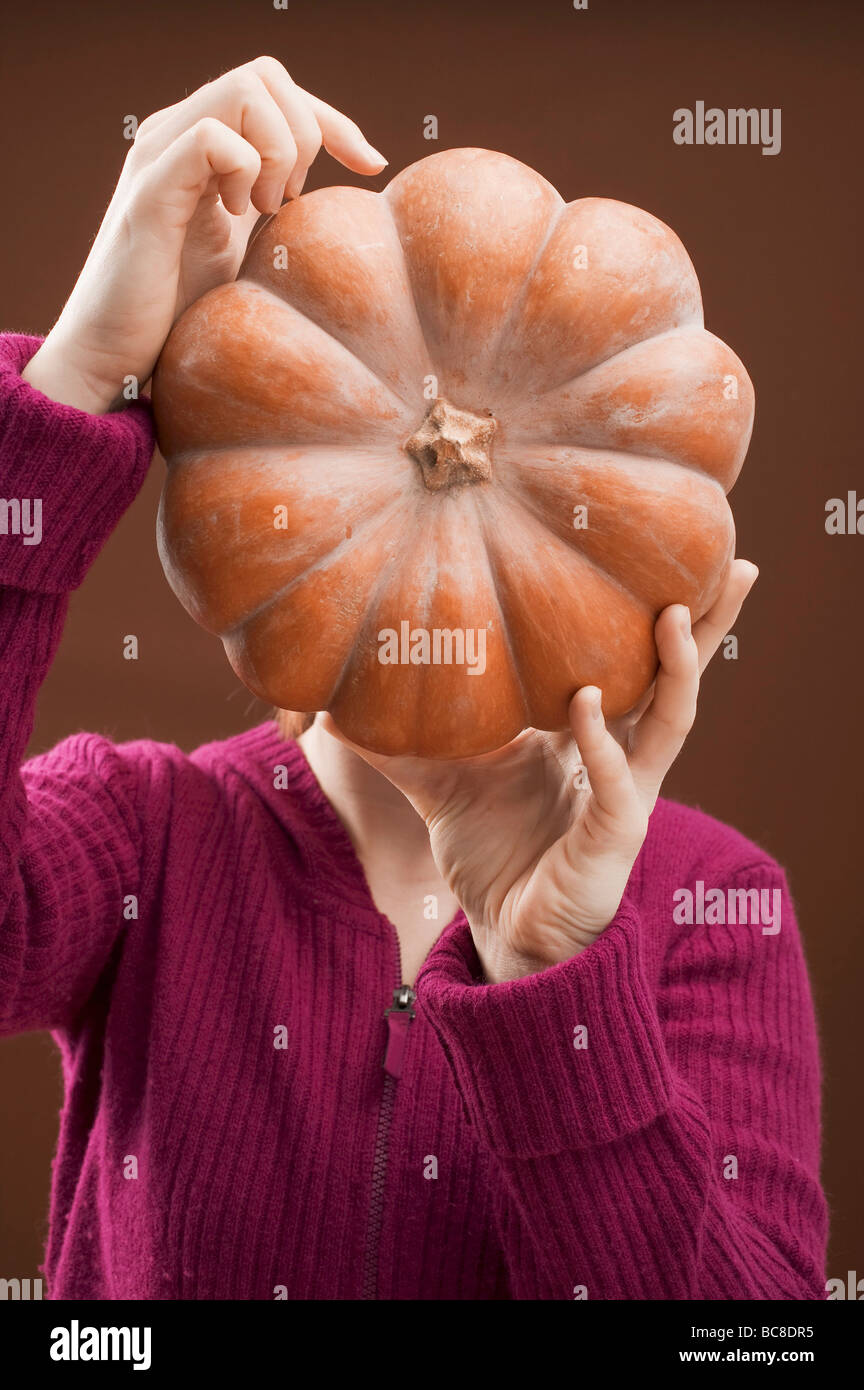 Woman holding pumpkin - Stock Photo