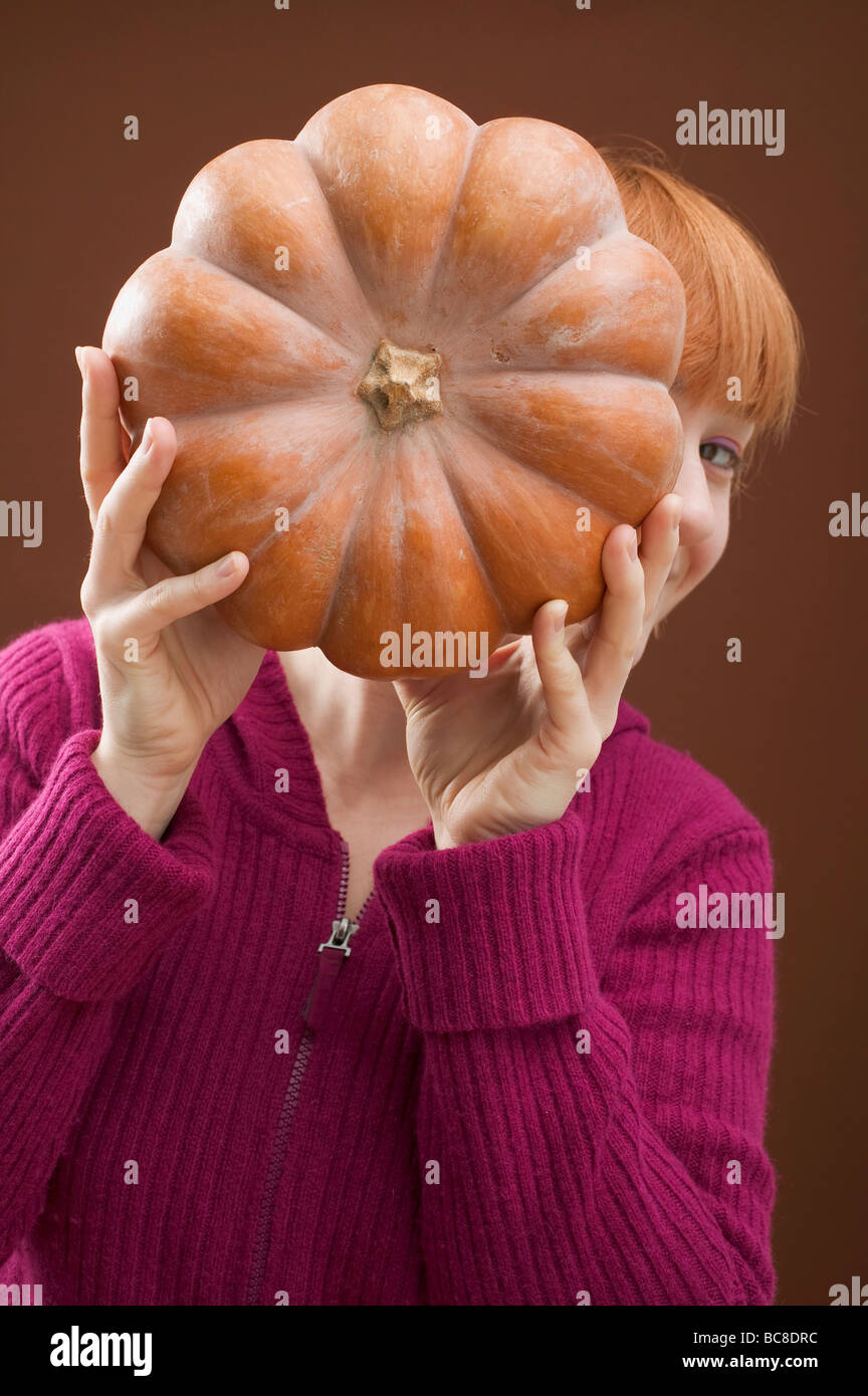 Woman holding pumpkin - Stock Photo