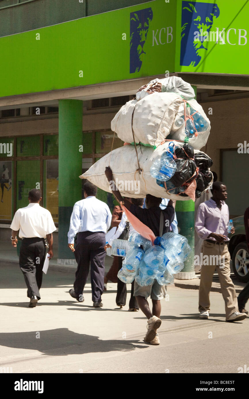 African man carrying empty plastic bottles on his head. Dar es Salaam Tanzania Stock Photo