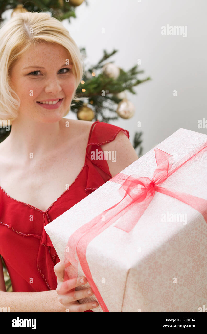 Woman holding Christmas parcel Stock Photo - Alamy