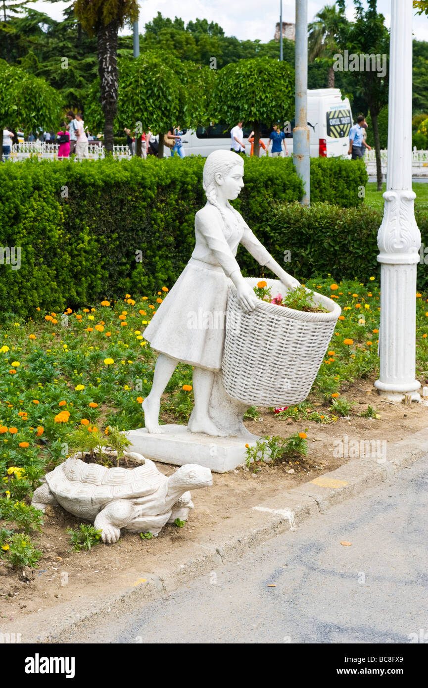 Turkey , Istanbul , Sultanahmet Square or Meydani , with gardens with flower pots figures of young girl with basket & tortoise Stock Photo