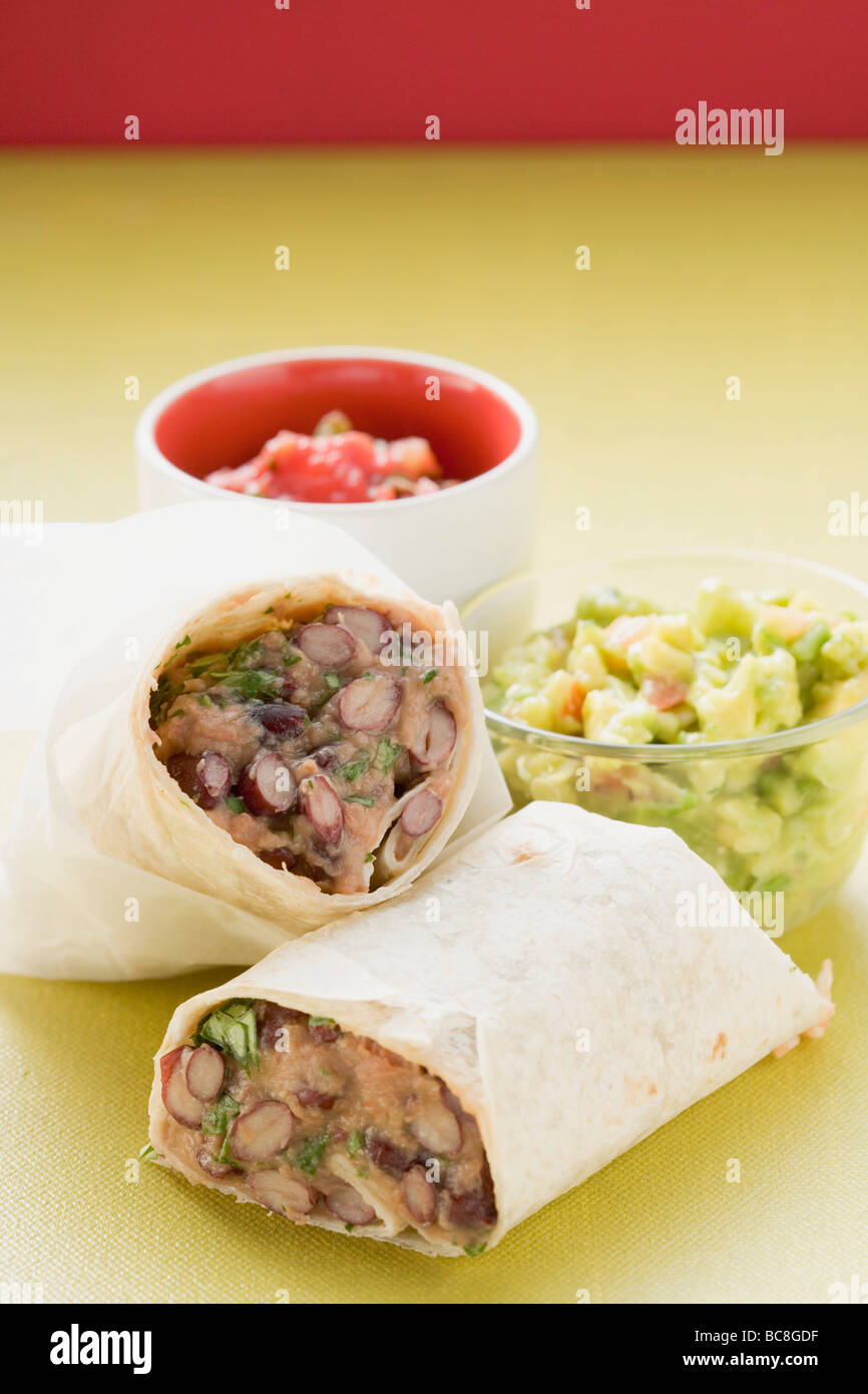 Bean burritos, guacamole and salsa in small bowls Stock Photo Alamy