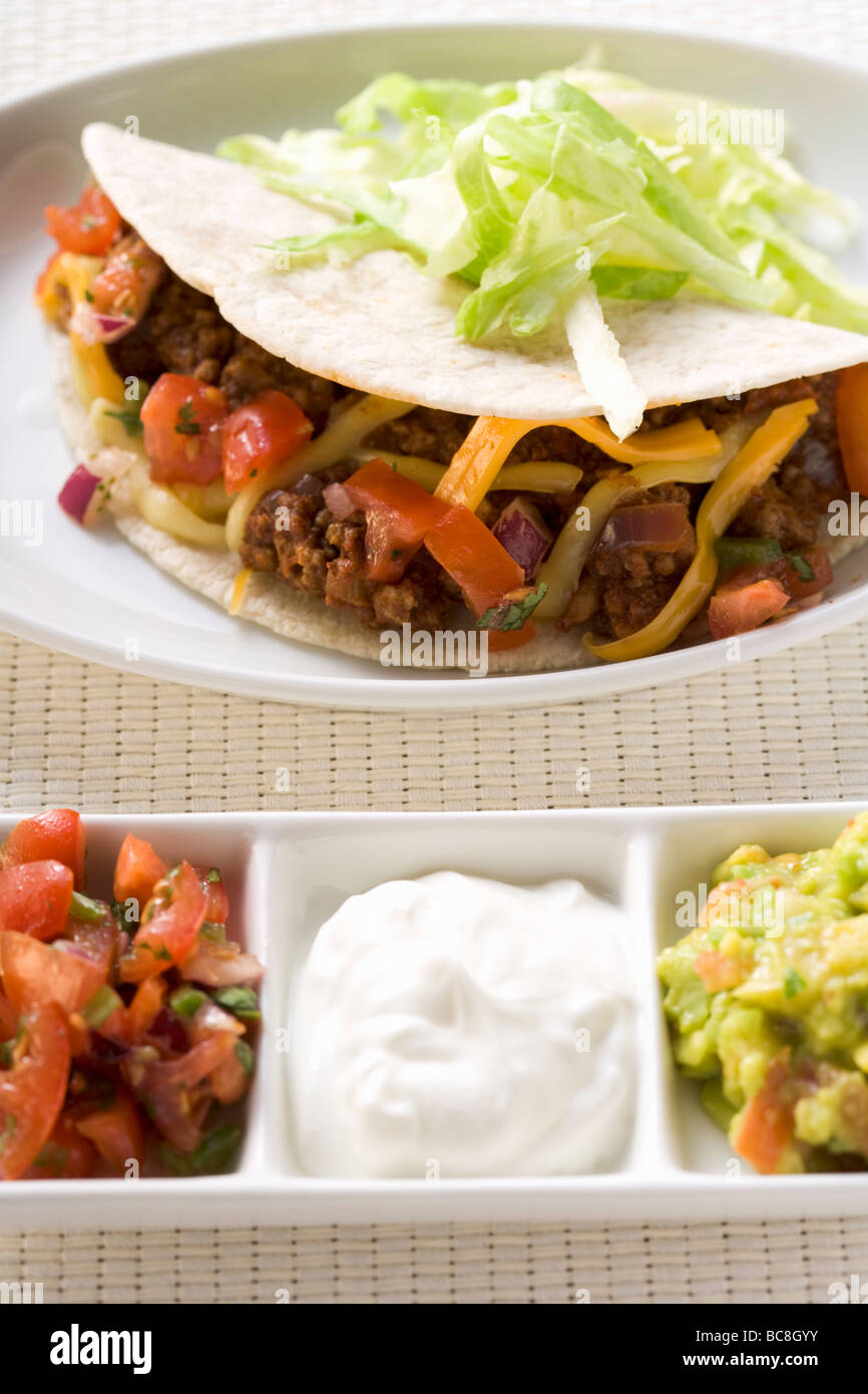 Mince taco with salsa, sour cream, guacamole (Mexico Stock Photo Alamy