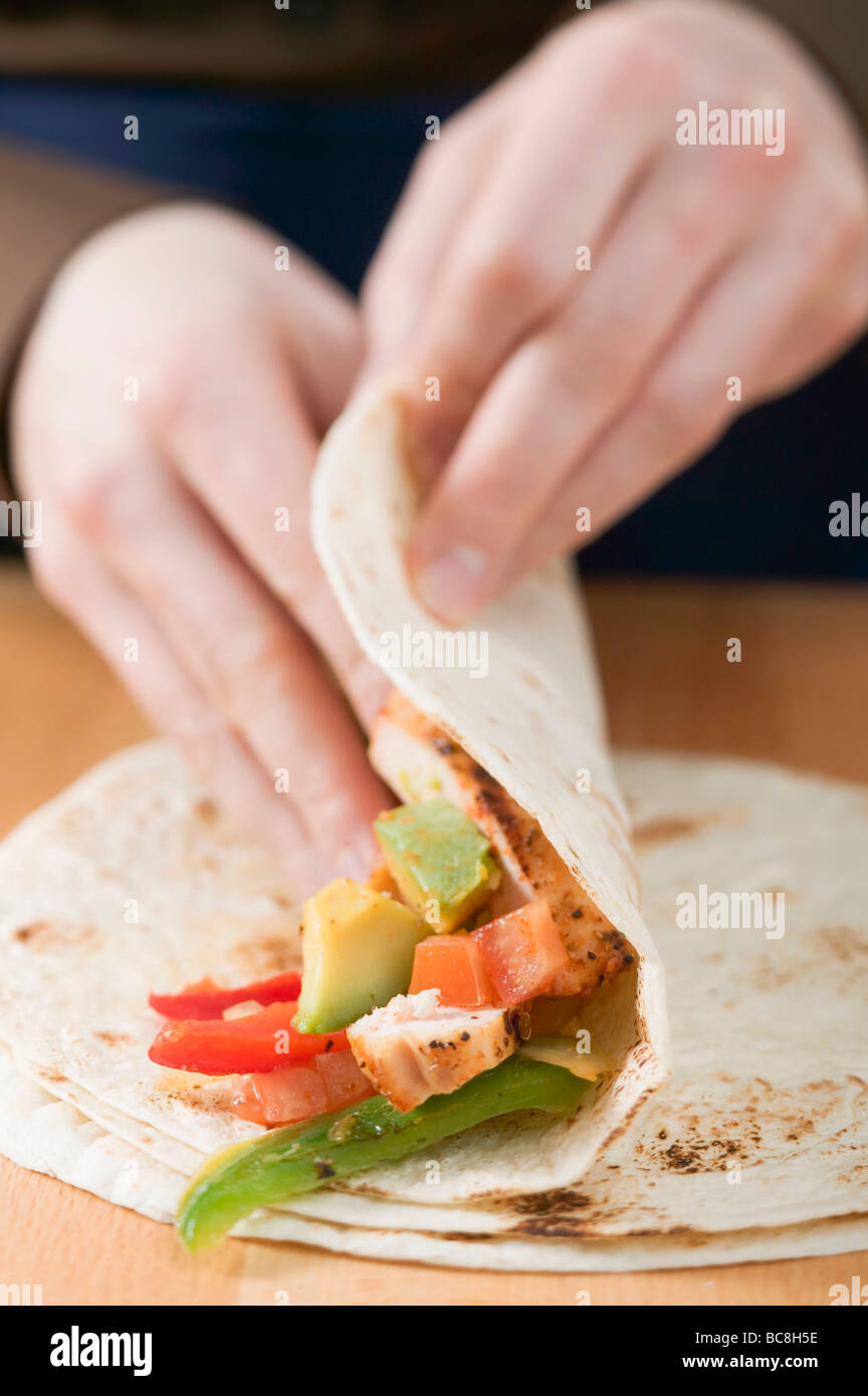 Folding a chicken wrap Stock Photo Alamy