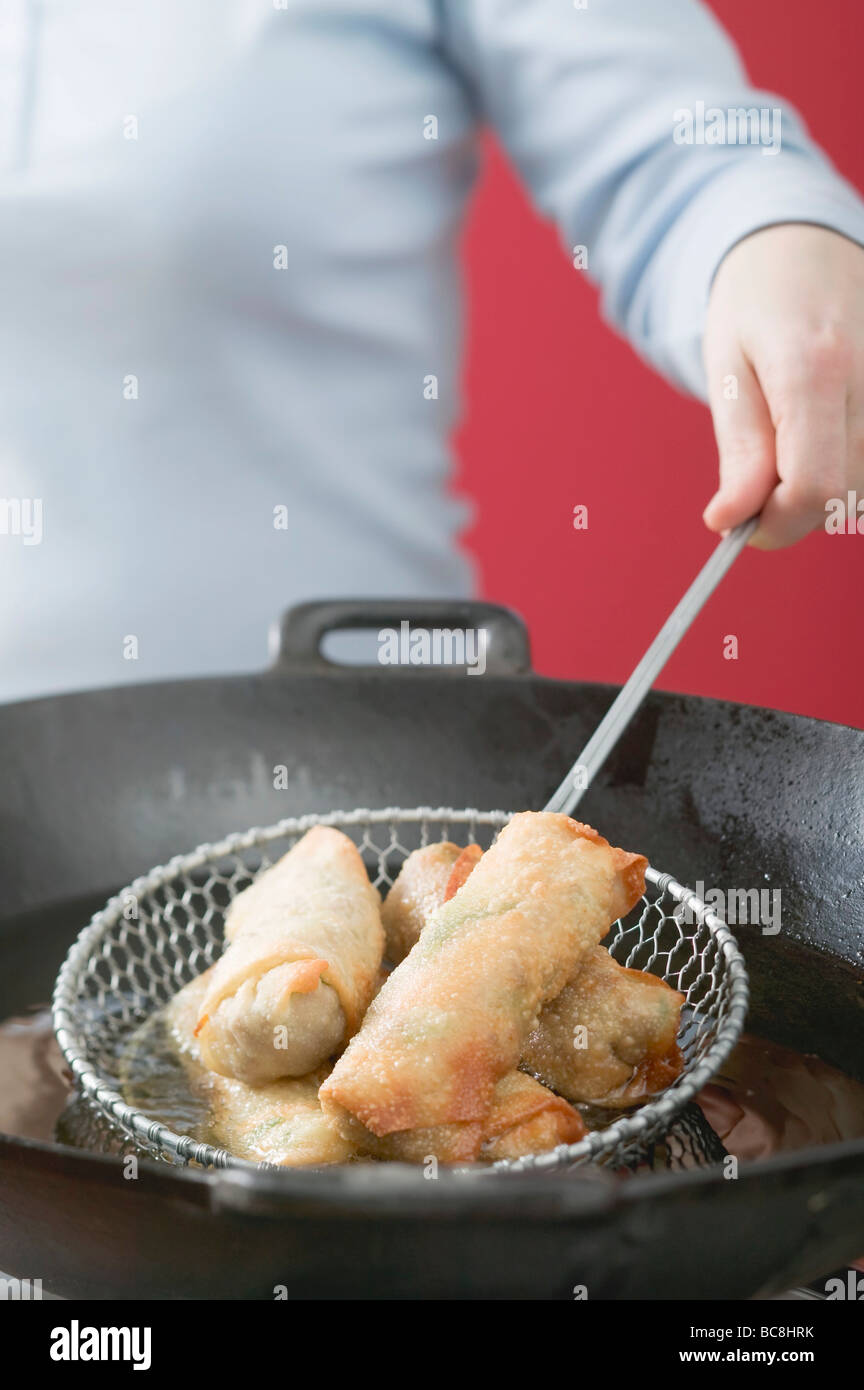 Deepfrying spring rolls in wok Stock Photo Alamy