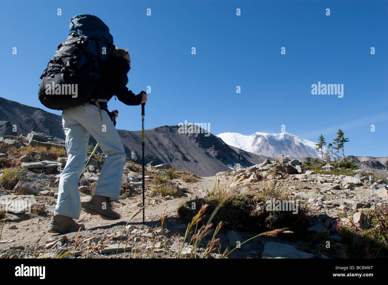 A woman backpacking the wonderland trail through Mt. Rainier National ...