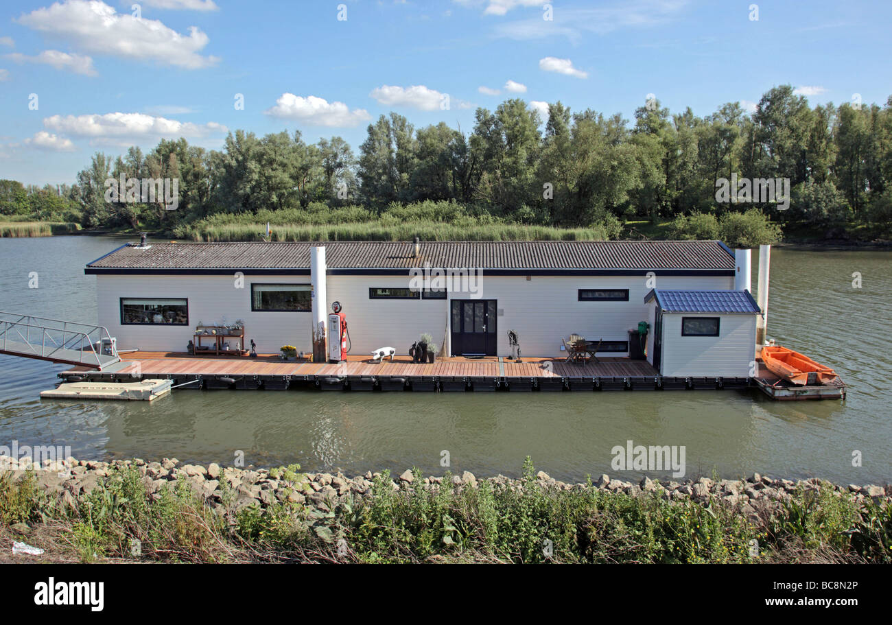 Houseboat on the River Lek decorated with plastic pig and petrol pump  South Holland The Netherlands Europe Stock Photo