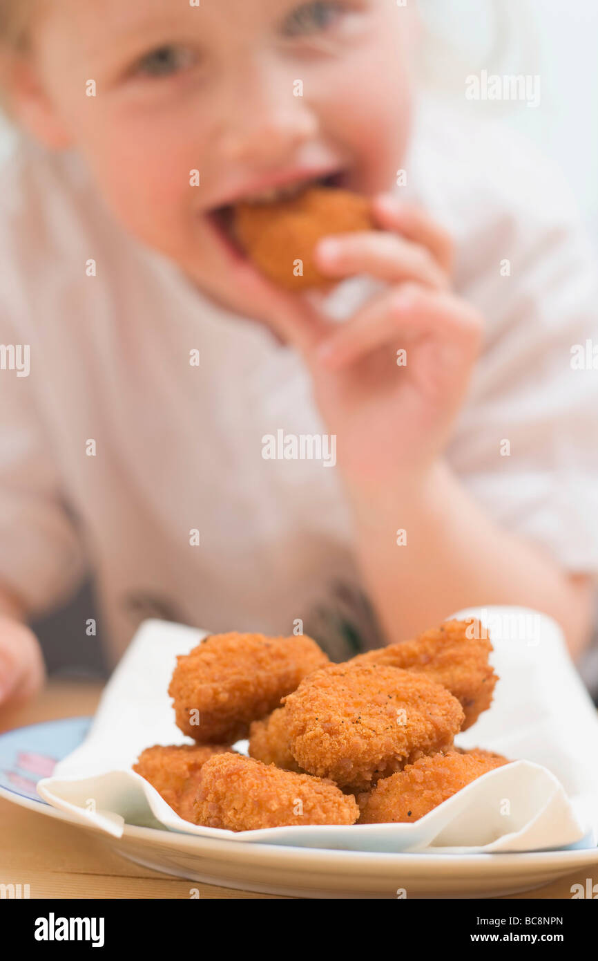 Little girl eating chicken nuggets Stock Photo Alamy
