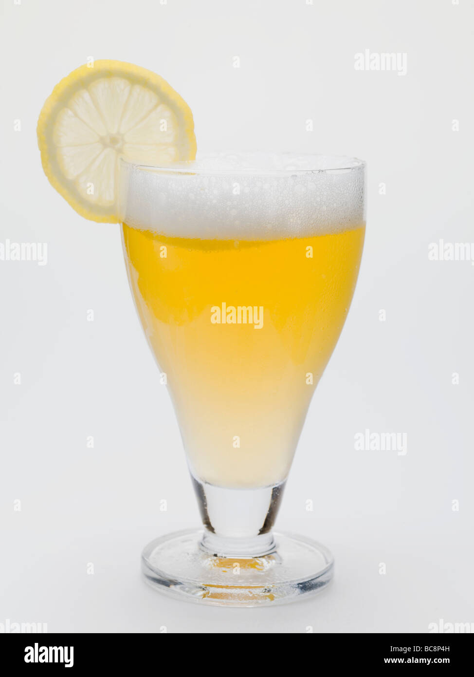 Glass of shandy with slice of lemon (UK) - Stock Photo