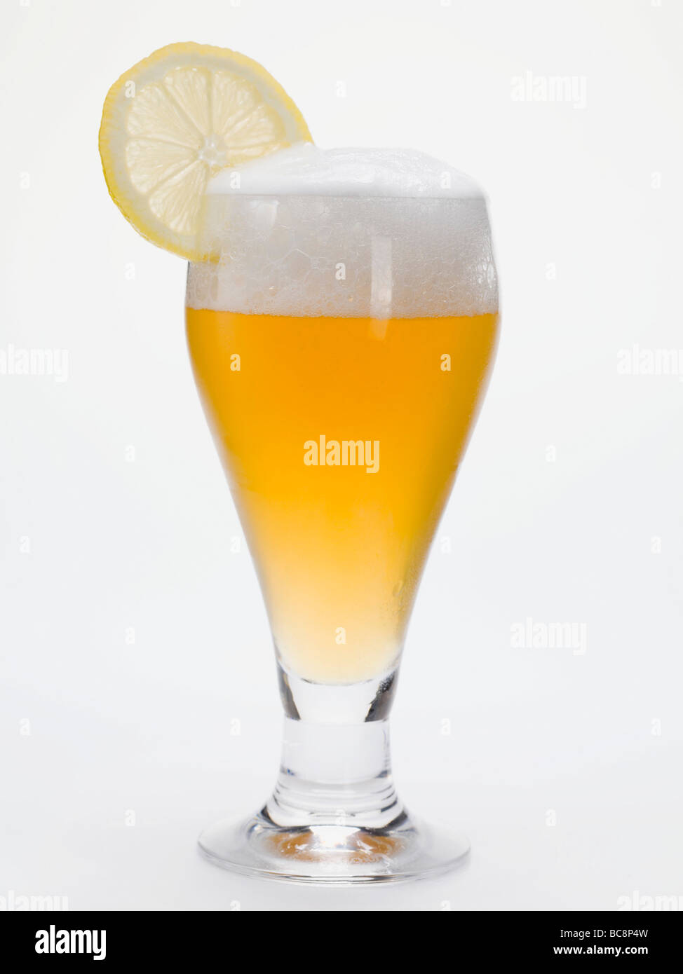 Glass of shandy with slice of lemon (UK) - Stock Photo