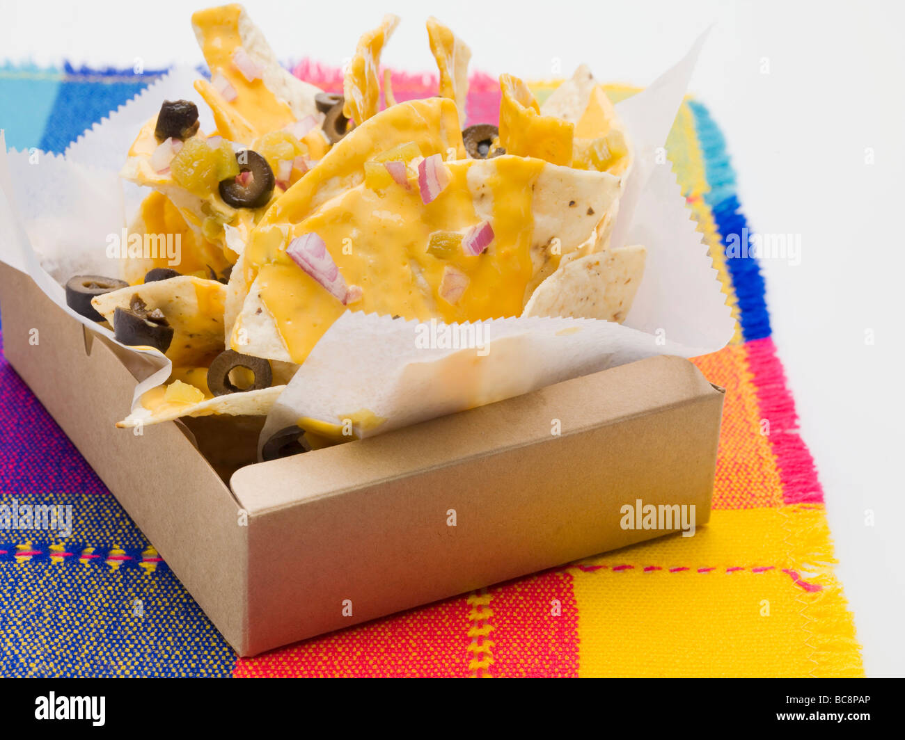 Tortilla chips with cheese, olives and onions to take away Stock Photo