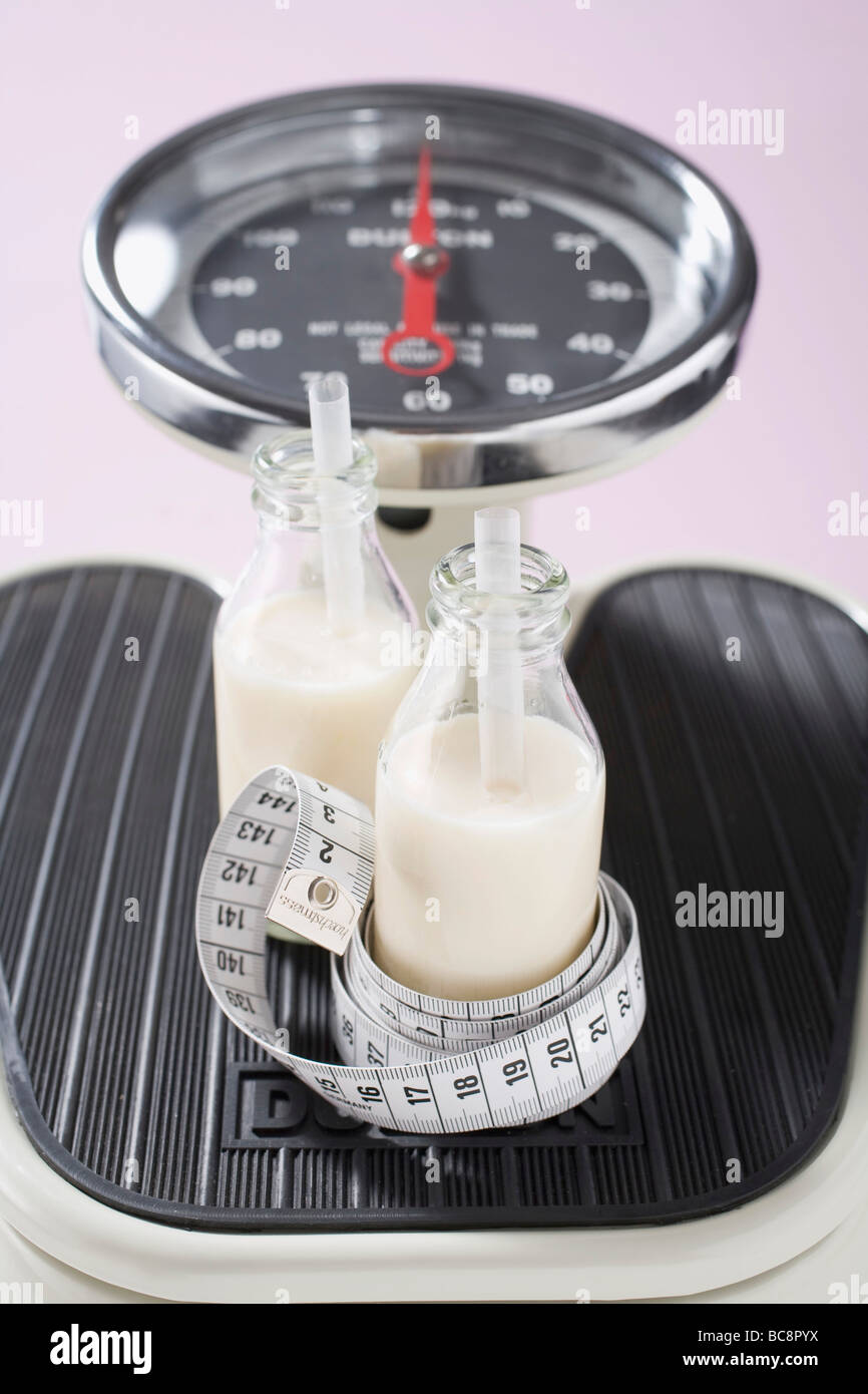 Cheesemaker measuring temperature with thermometer in a large steel tank  full of milk Stock Photo - Alamy