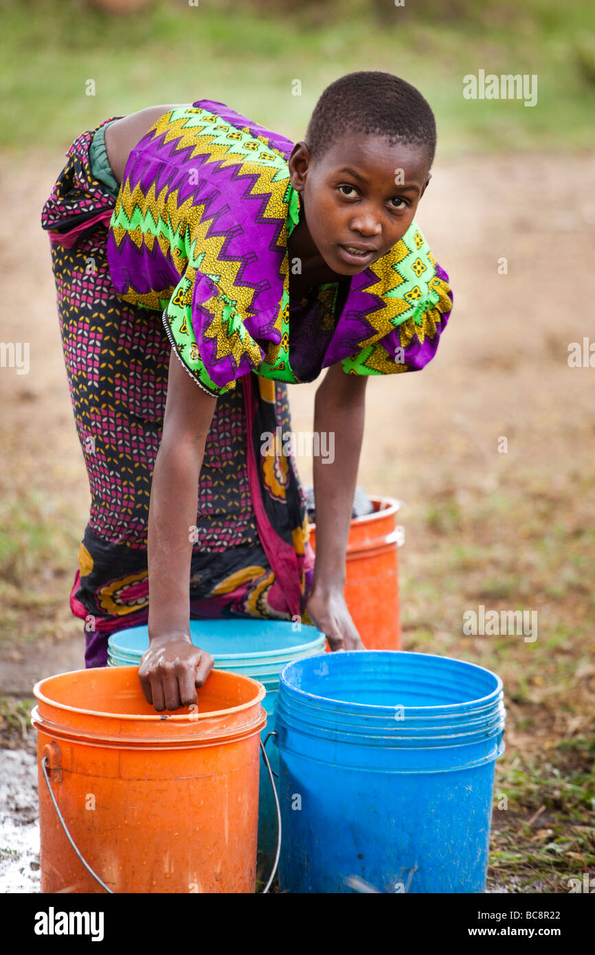 https://c8.alamy.com/comp/BC8R22/african-girl-washing-laundry-by-hand-in-brightly-coloured-buckets-BC8R22.jpg