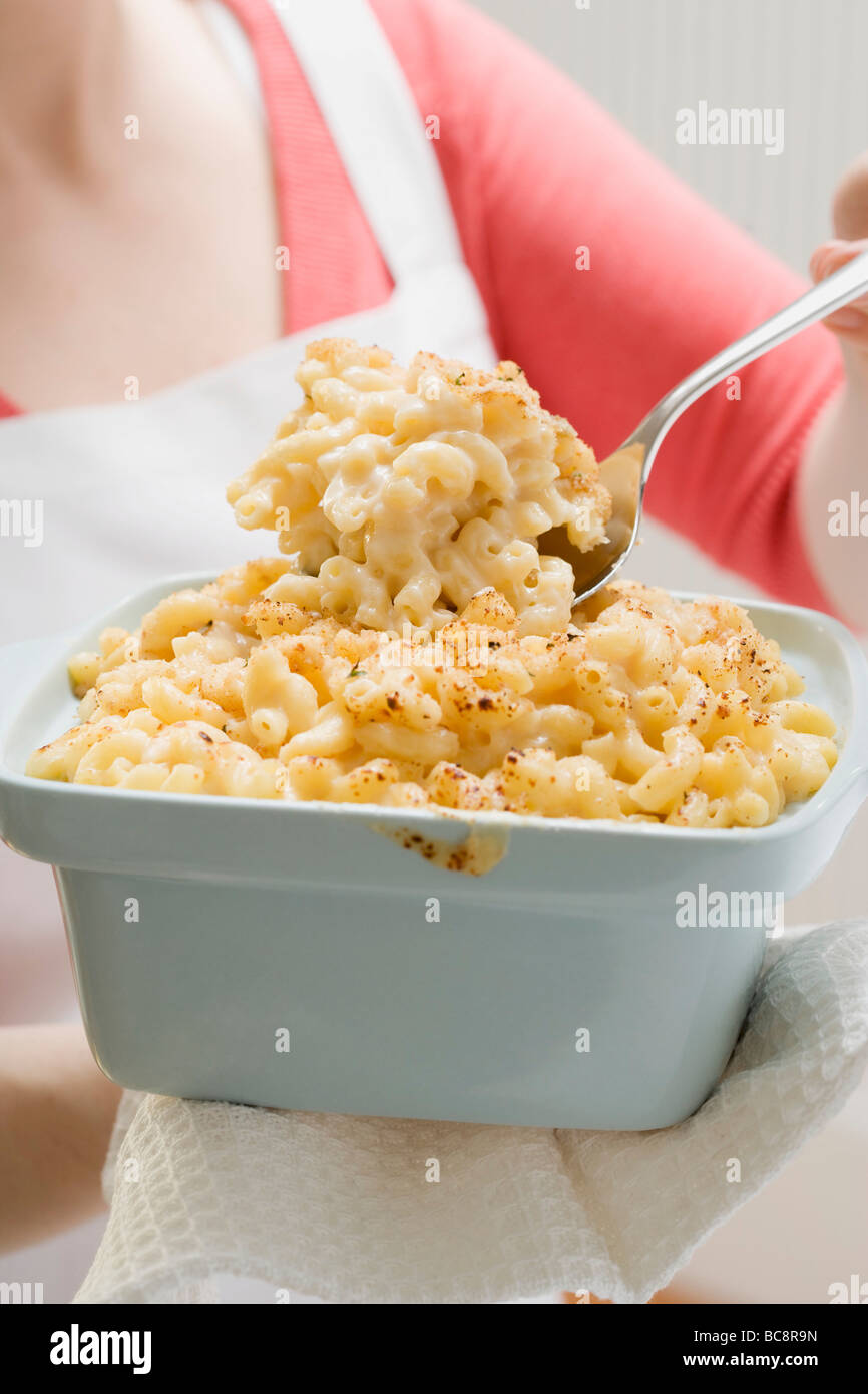 Woman serving macaroni cheese Stock Photo Alamy