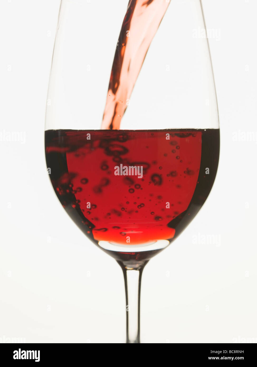 Pouring red wine into a glass Stock Photo Alamy