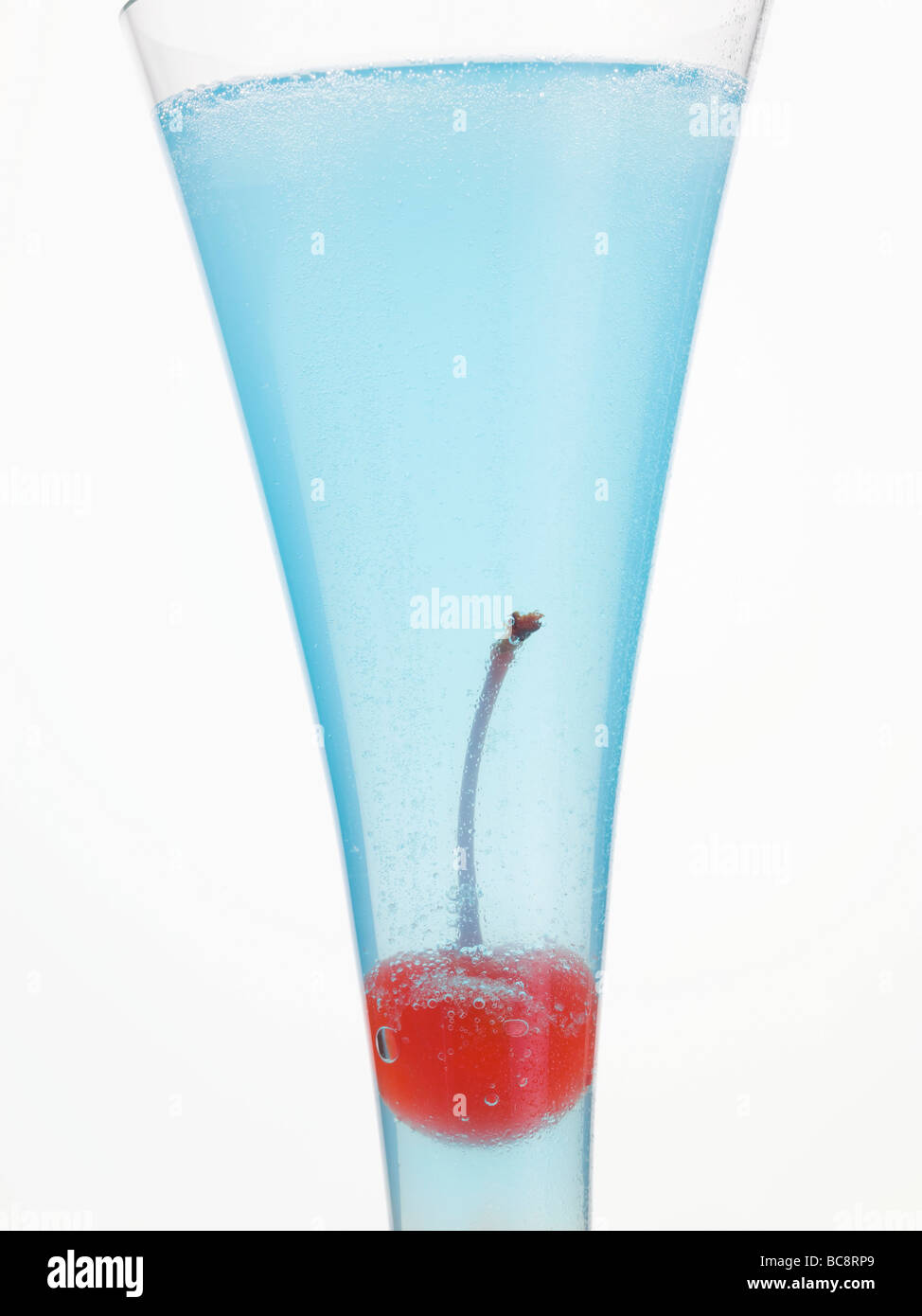 Sparkling wine cocktail with Blue Curaçao & cocktail cherry Stock Photo Alamy