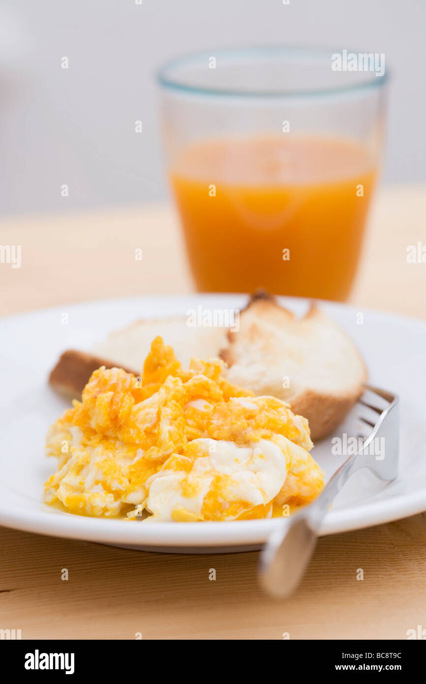Scrambled egg, toast and glass of fruit juice Stock Photo - Alamy