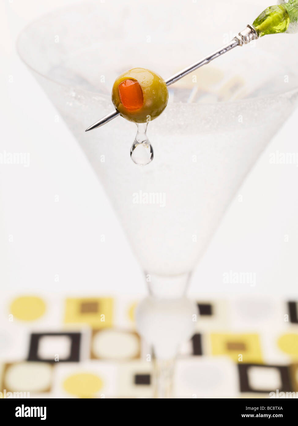 Martini with olive on cocktail stick Stock Photo Alamy