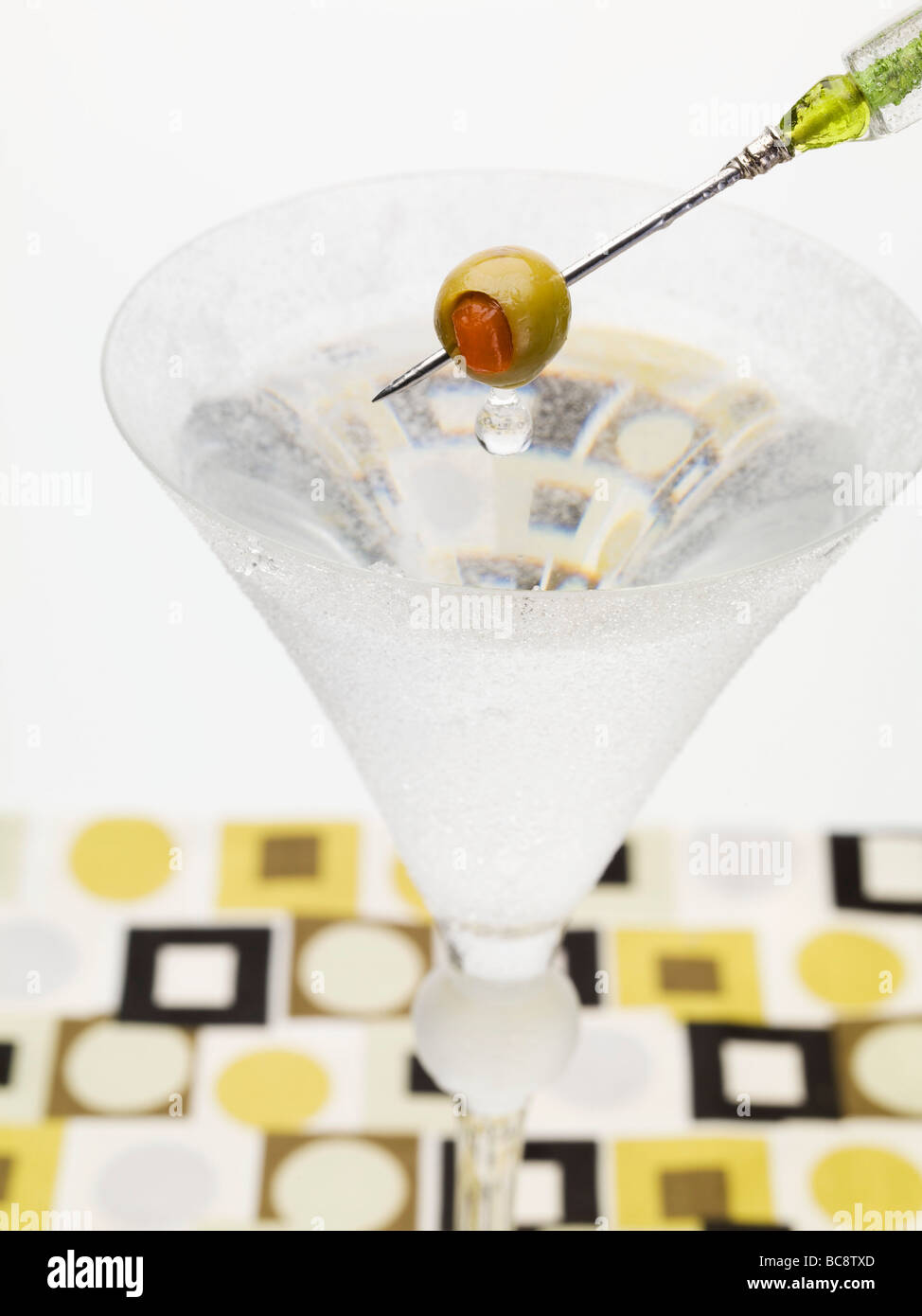 Martini with olive on cocktail stick Stock Photo Alamy