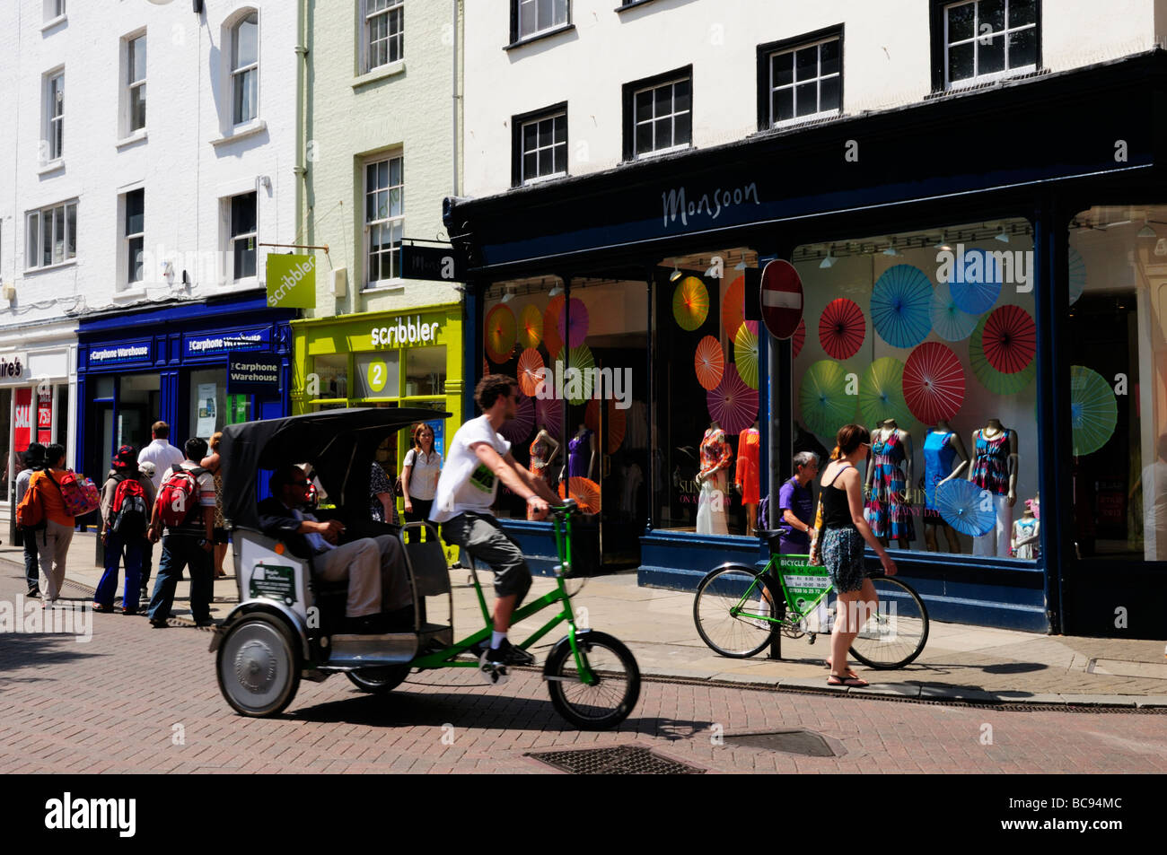 A pedicab cycle rickshaw carrying tourists in  Market Street in the city centre, Cambridge England UK Stock Photo