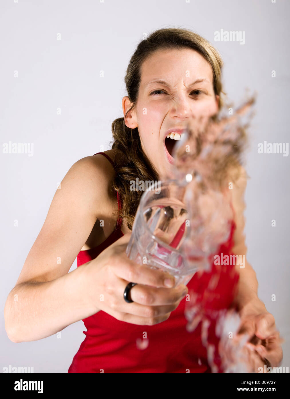 A Young woman throwing a drink at the camera Stock Photo Alamy