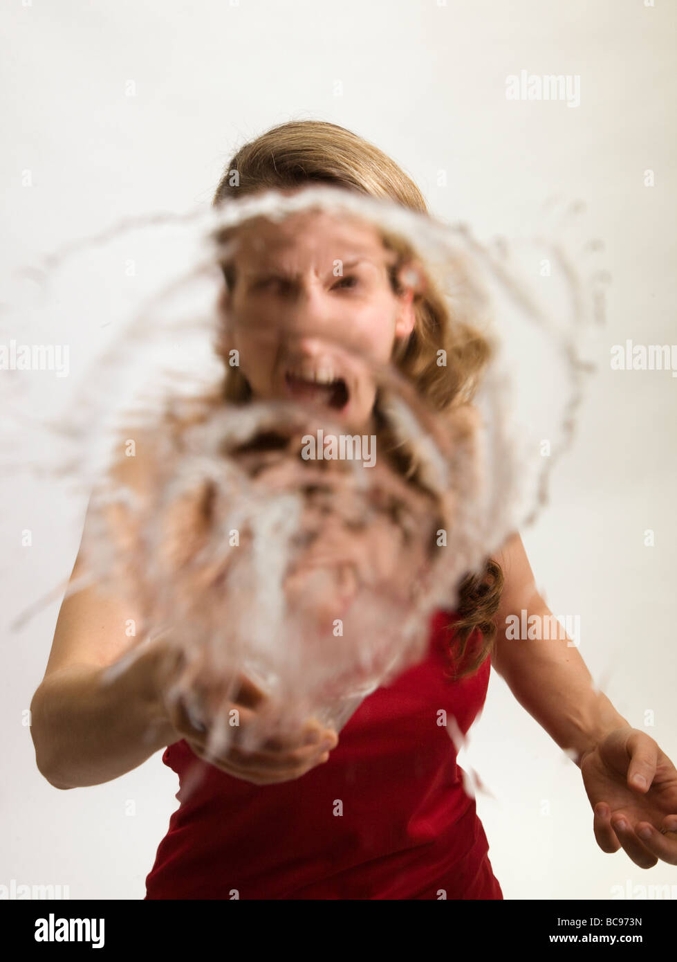 A Young woman throwing a drink at the camera Stock Photo Alamy