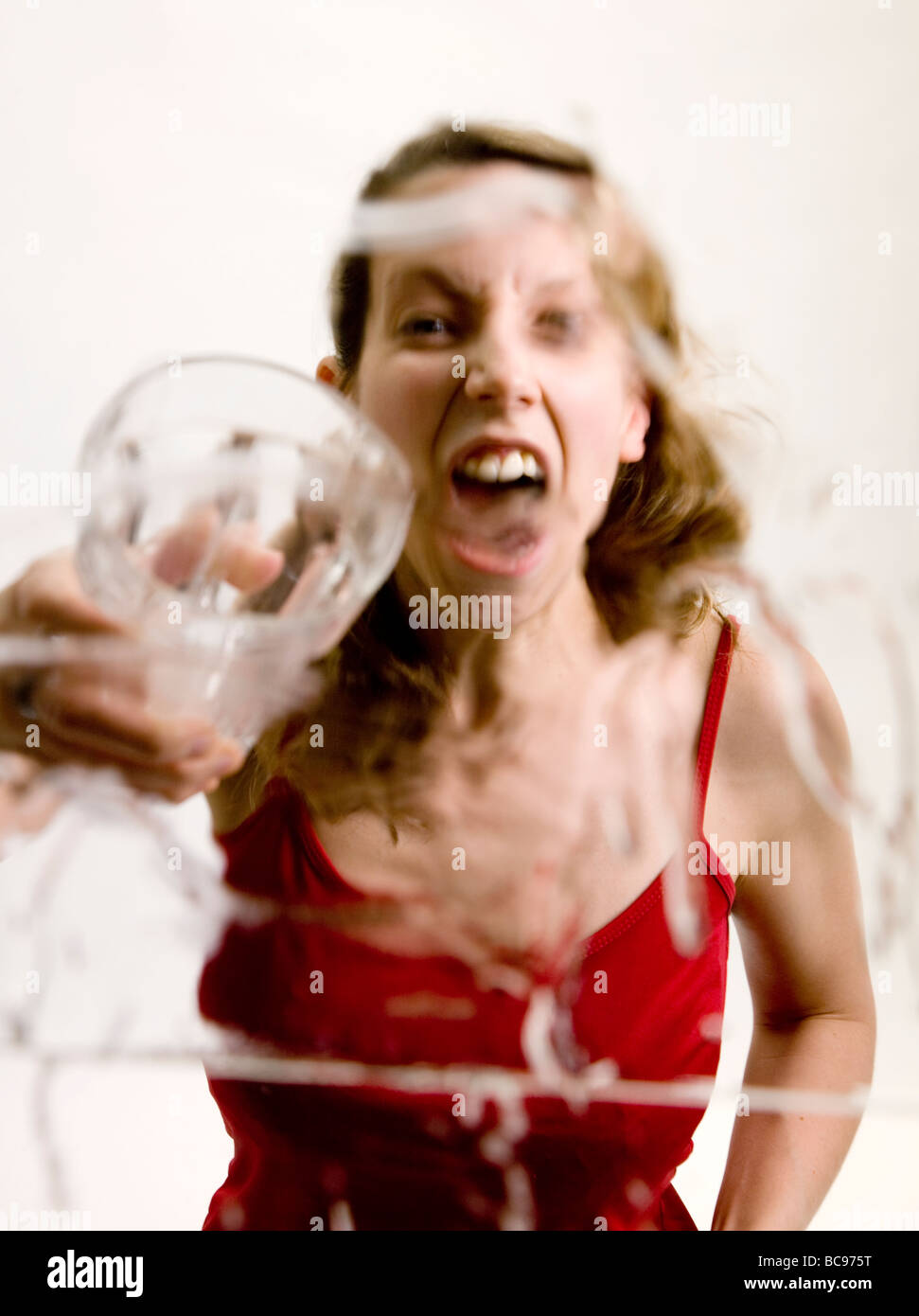 A Young woman throwing a drink at the camera Stock Photo Alamy