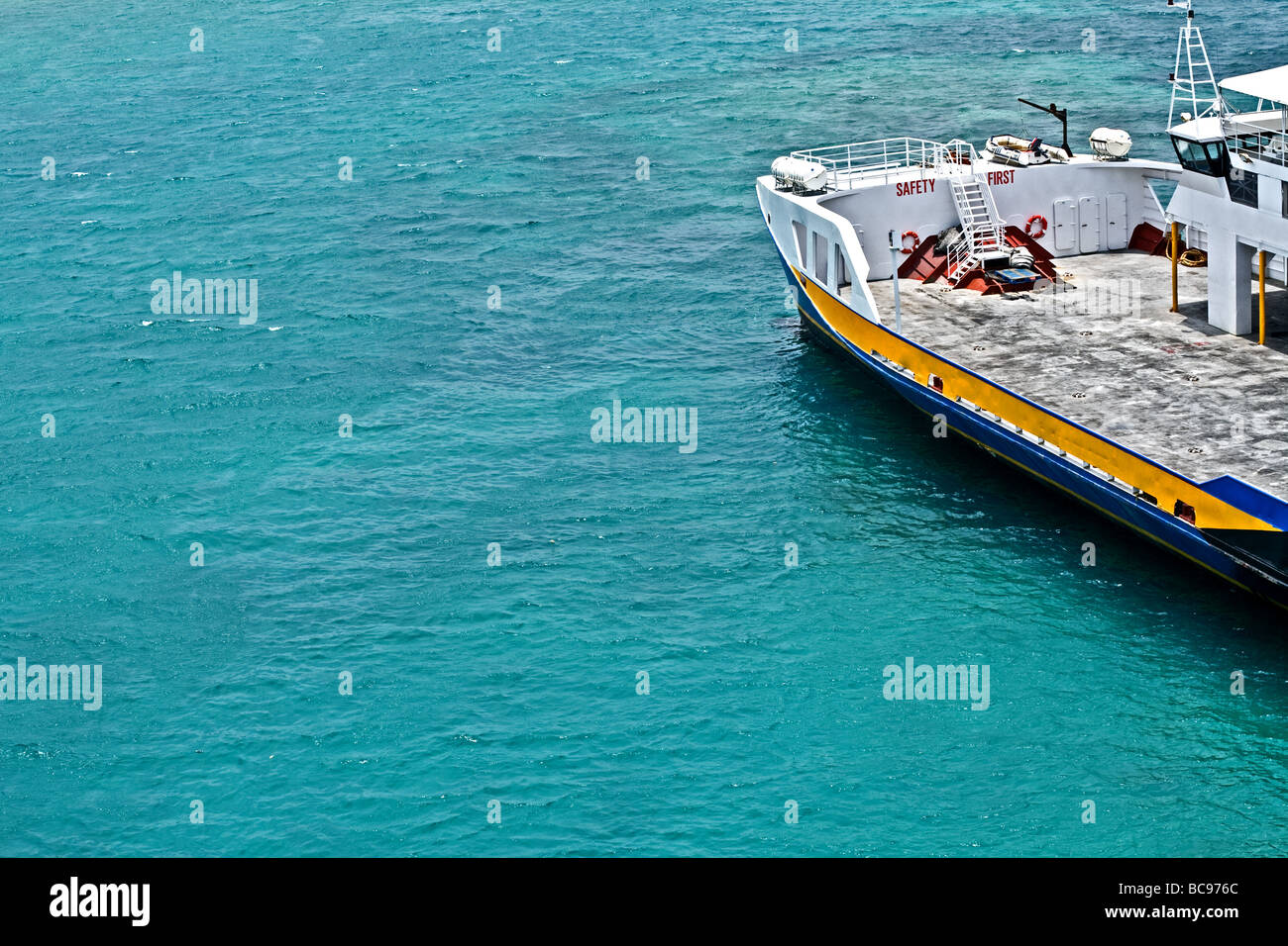 boat in the bay in Nassau, Bahamas with a 'safety warning' painted on the deck Stock Photo