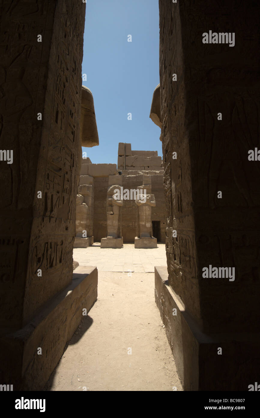 Statues glimpsed through a gap in the columns of the temple of Ramses ...